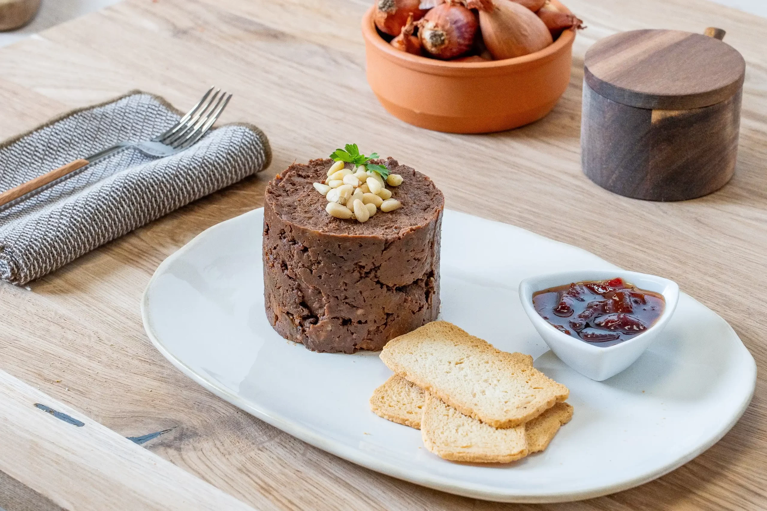 Timbal de morcilla con cebolla caramelizada y piñones